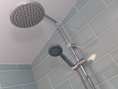 A shower with a fixed and handheld showerhead at Costentyn, Tor Down Quarry St Breward