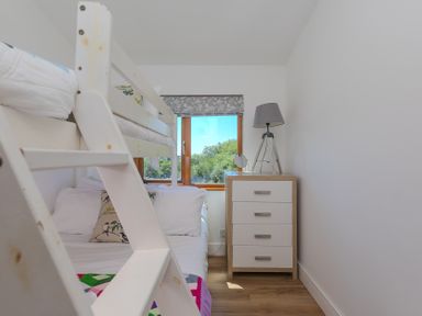 A bedroom with a bunk bed and a chest of drawers at Costentyn, Tor Down Quarry St Breward