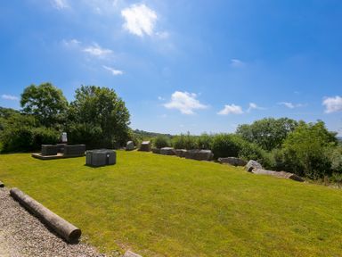 A garden with grass and outdoor seating at Costentyn, Tor Down Quarry St Breward