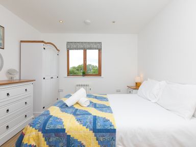A bedroom with a double bed and wardrobe at Tressa, Tor Down Quarry in St Breward