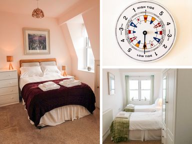 A bedroom with a double bed and two bedside lamps a circular tide clock on a wall and a bedroom with two single beds and a wardrobe at 10 Oceanside in Ilfracombe