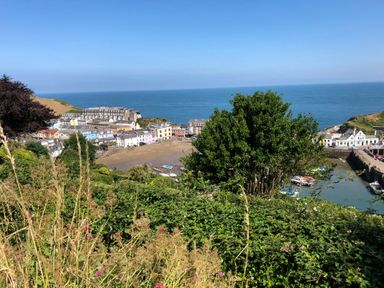 A coastal village with houses near a harbor and the sea visible beyond at 10 Oceanside in Ilfracombe
