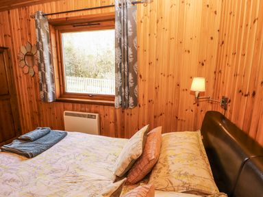 A bedroom with a bed and window at 26 Dukes Meadow in Greystoke near Penrith