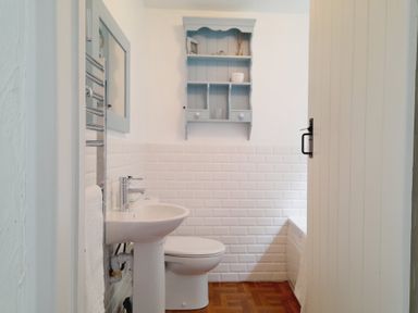 A bathroom with a sink and toilet at Crab Cottage in Ilfracombe