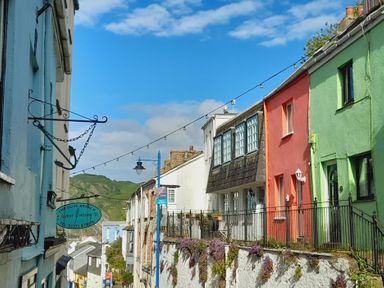 Houses along a street with a view of mountains at Crab Cottage Ilfracombe