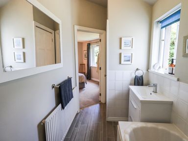 A bathroom with a sink and mirror at Doe Foot Cottage Ingleton