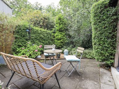 A garden with seating and a table at Doe Foot Cottage Ingleton