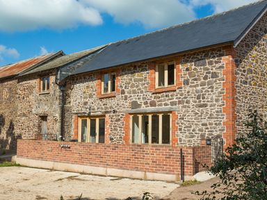 Stone and brick cottage with slate roof and small brick wall in front at Salters in Black Dog near Crediton