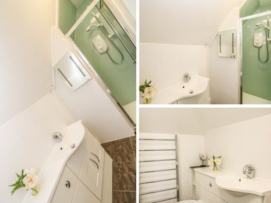 A bathroom with a curved sink and cabinet a glass-enclosed shower and a towel rack at Bolenowe Trebetherick near Polzeath
