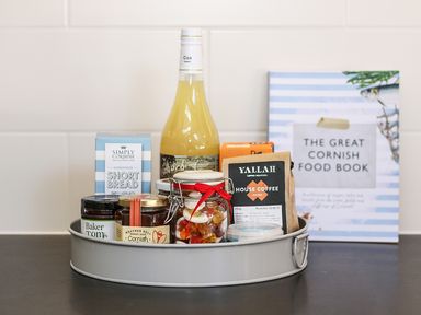 A tray with various jars food items and a book titled The Great Cornish Food Book at Long House Boskensoe Barns in Mawnan Smith