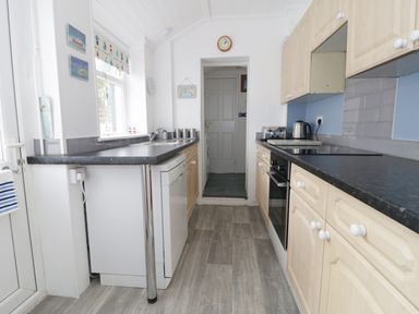 A kitchen with countertops cabinets dishwasher oven and kettle at No 9 in Watchet