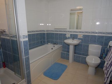 A bathroom with a bathtub sink toilet and shower at Pine Cottage in Maenporth