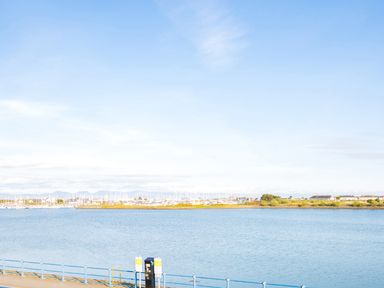 A view of a body of water with boats and buildings in the background at 7 Marina View Pwllheli