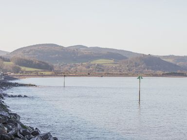 A coastal scene with water and hills in the background at The Old Byres in Washford near Watchet