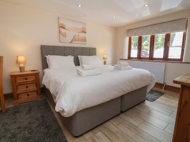 A bedroom with a double bed and bedside table at The Old Byres in Washford near Watchet