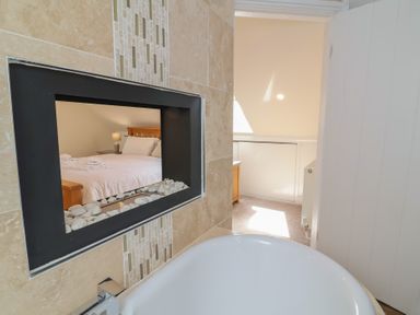 A bathroom with a view of a bedroom at The Old Byres Washford near Watchet
