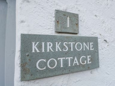 Signs on a wall displaying number 1 and Kirkstone Cottage