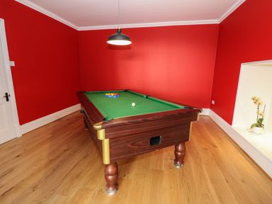 A room with a pool table balls and a light hanging above at Oakwood House in Rhayader