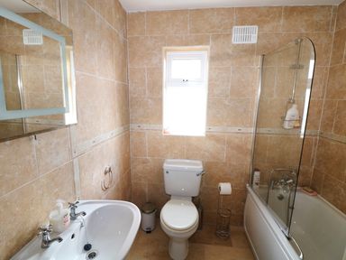 A bathroom with a sink toilet and bathtub with shower at Benbulben View in Tullaghan County Leitrim