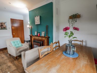A dining room with a table and chairs at Blaenywawr near Lampeter
