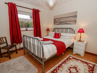 A bedroom with a bed and a bedside table at Blaenywawr near Lampeter