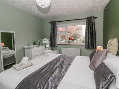 A bedroom with a bed and dresser at Blaenywawr near Lampeter