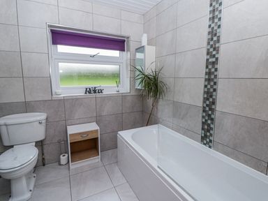 A bathroom with a bathtub and toilet at Blaenywawr near Lampeter
