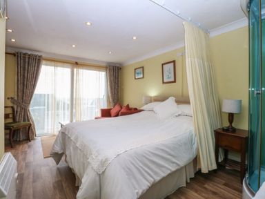 A bedroom with bed and seating area at Maesawel Studio in Llanfair