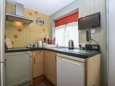 A kitchen with a sink and appliances at Maesawel Studio in Llanfair