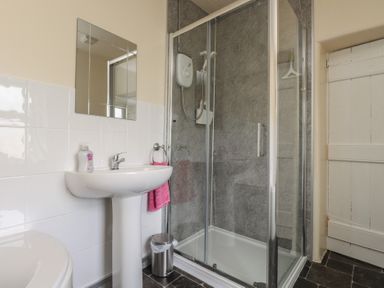 A bathroom with a sink and shower at The Farmhouse in Brynsiencyn near Newborough
