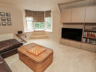 A living room with a coffee table and television at Kelsick Heights in Ambleside