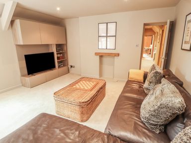 A living room with a sofa and coffee table at Kelsick Heights in Ambleside