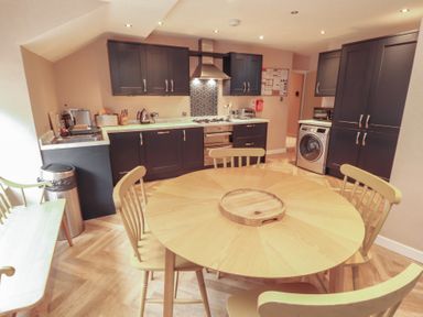 A kitchen with a dining table and chairs at Kelsick Heights in Ambleside