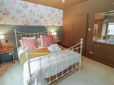 A bedroom with a bed and nightstands at Kelsick Heights, Ambleside