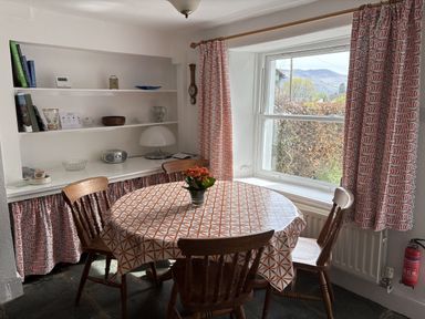 A dining room with a table and chairs at Prospect Lodge in Portinscale