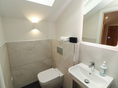 A bathroom with a toilet and hand basin at Mell View Cottage in Ullswater