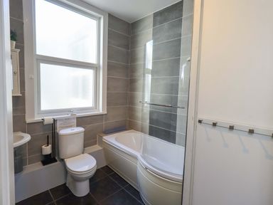 A bathroom featuring a bathtub, toilet, and sink at St Johns View in Keswick