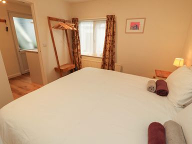 A bedroom with a bed and towels at Archers in Keswick