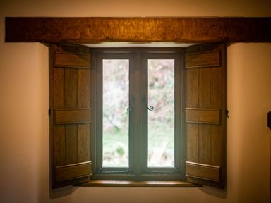 A window with open wooden shutters and a wooden beam above it at Grayrigg Foot Stable in Grayrigg