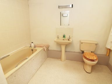 A bathroom with a bathtub sink and toilet at Low Skelgill in Troutbeck