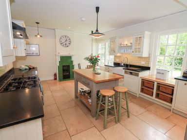 A kitchen with an island and stools at Little Ellers in Portinscale near Keswick