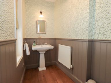 A bathroom with a sink and a mirror at Little Ellers in Portinscale near Keswick