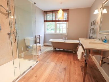 A bathroom with a shower and bathtub at Little Ellers in Portinscale near Keswick