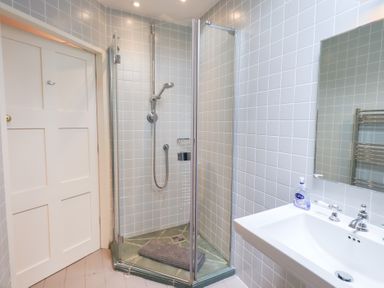 A bathroom with a shower and sink at Little Ellers in Portinscale near Keswick