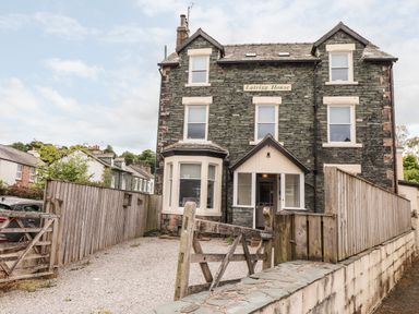 A stone house with multiple windows and a wooden gate in front at Latrigg House in Keswick