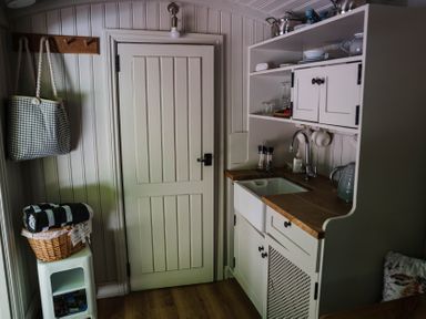 A kitchen with a sink and storage at The Snug in Longtown