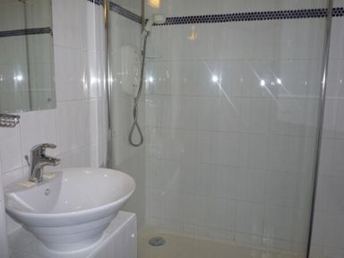 A bathroom with a sink and a walk in shower at 20 Keswick Bridge in Keswick
