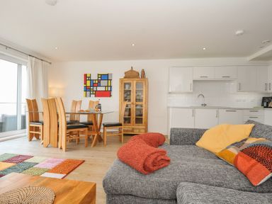 A living room with a dining area and kitchen units at The View in Newquay