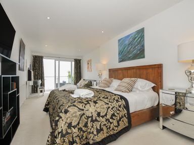 A bedroom with a bed and television at The View in Newquay