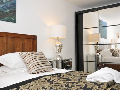 A bedroom with a bed and bedside lamp at The View in Newquay
